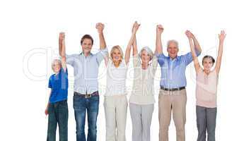 Smiling family raising their arms