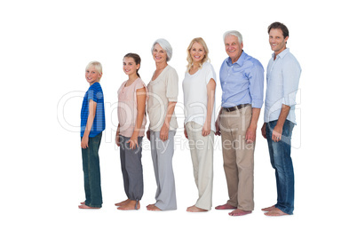 Multi-generation family posing together and looking at camera