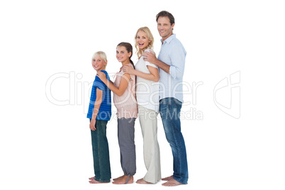 Family posing together and looking at camera