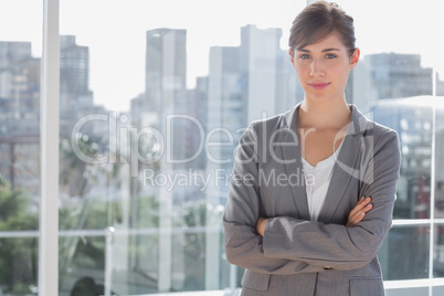 Happy businesswoman beside large window