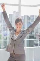 Successful businesswoman cheering and smiling