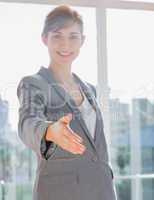 Businesswoman smiling with hand out