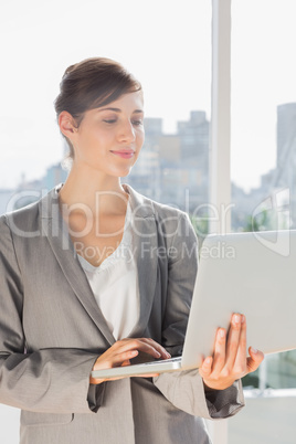 Pretty businesswoman working on laptop