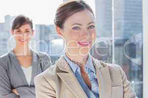 Happy businesswomen with arms crossed