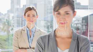 Two smiling businesswomen looking at camera