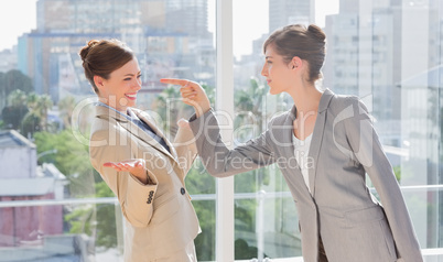 Businesswoman pointing at her rival