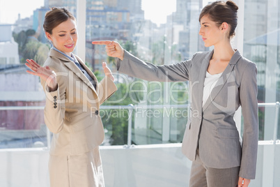 Angry businesswoman pointing at her rival