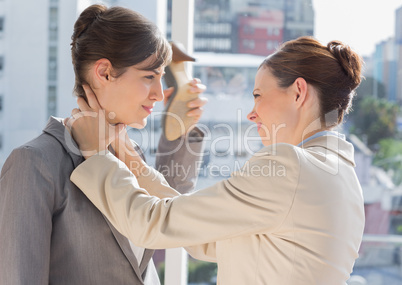 Businesswoman strangling another