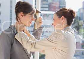 Businesswoman strangling another