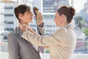 Businesswoman strangling another who is defending with her shoe