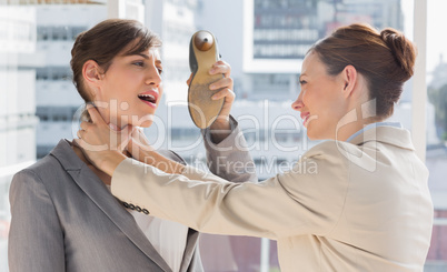 Businesswoman defending herself from her colleague strangling he