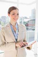 Happy businesswoman using her tablet pc