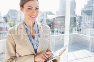 Pretty businesswoman using her tablet pc