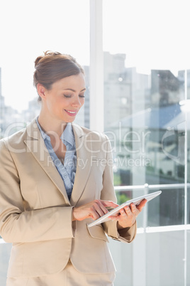 Beautiful businesswoman using her tablet pc