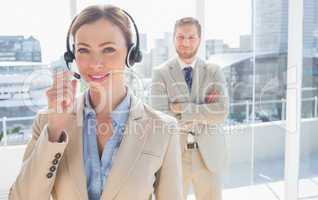 Call centre worker standing with colleague behind her