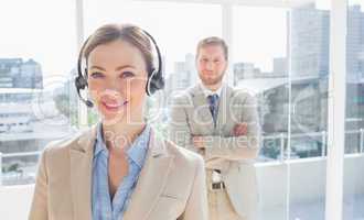 Call centre agent standing with colleague behind her