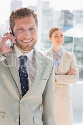 Happy businessman having phone conversation