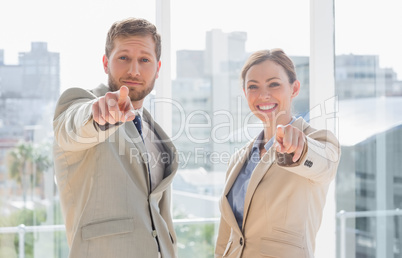 Business team pointing at camera