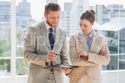 Business team going over document on clipboard