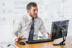 Frustrated businessman looking at his computer