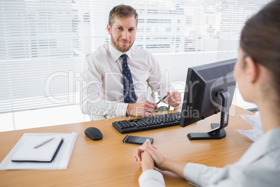Businessman smiling at camera in his office