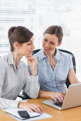 Businesswomen working together on a laptop