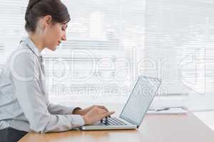 Businesswoman working on her laptop at desk