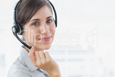 Pretty call centre agent smiling at the camera