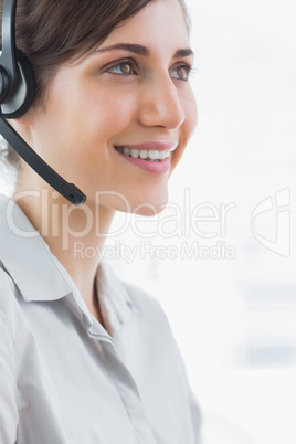 Pretty call centre agent smiling close up