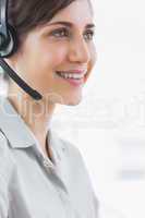 Pretty call centre agent smiling close up