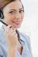 Call centre agent wearing headset smiling at camera