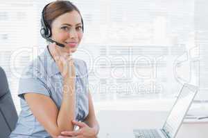 Call centre agent wearing headset at her desk