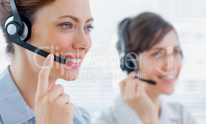 Call centre agents with headsets at work