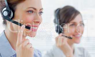 Call centre agents with headsets at work