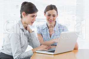 Two businesswomen working on laptop