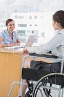 Businesswoman interviewing disabled job candidate