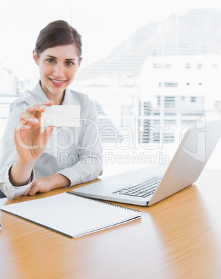 Pretty businesswoman showing blank business card