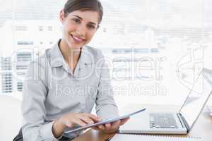 Businesswoman using digital tablet smiling at camera