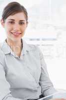 Portrait of a young businesswoman holding tablet pc