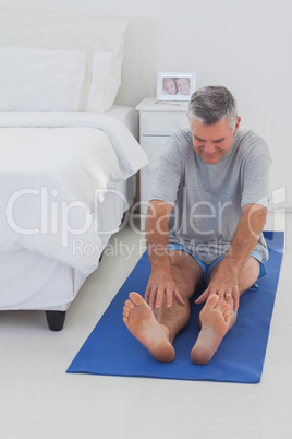 Mature man working out on mat