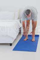 Man stretching on a mat