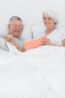 Mature woman showing her book to husband