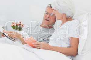 Mature couple looking at a newspaper