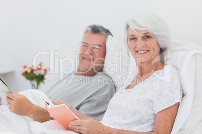 Portrait of a couple reading together in bed