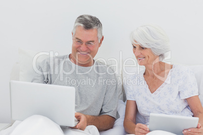 Mature man showing something on his laptop