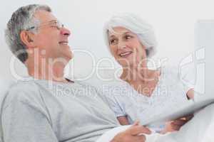 Cheerful mature couple using a laptop together