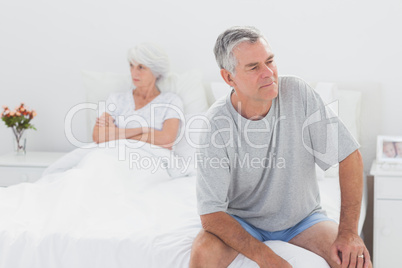 Angry man sitting in bed during a dispute