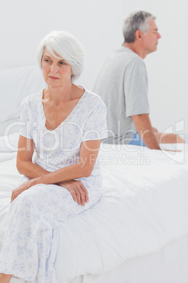 Angry woman sulking in bed during a conflict