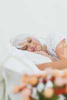 Peaceful woman sleeping in bed