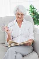 Woman reading a book on the couch